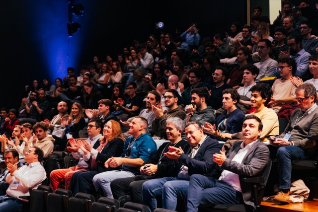 Attendees applauding in the auditorium at Blockchain Confluence 2025